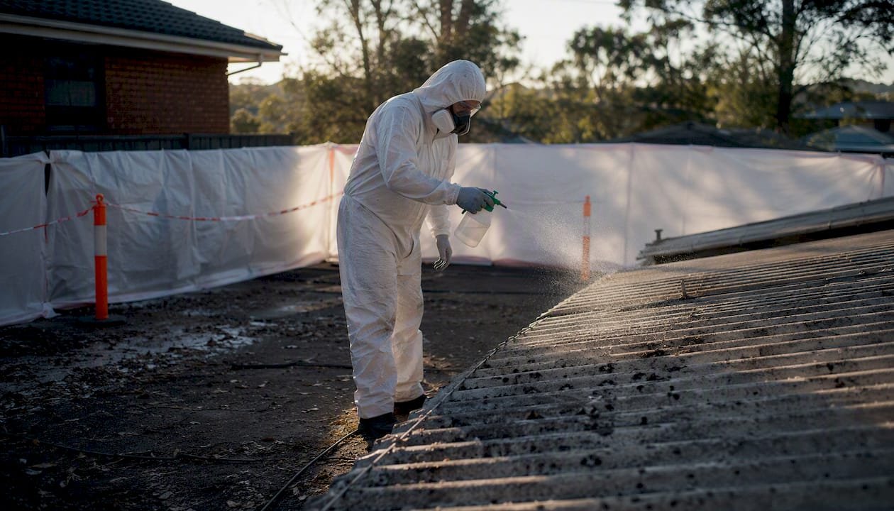 Wet spray asbestos removal procedure close-up