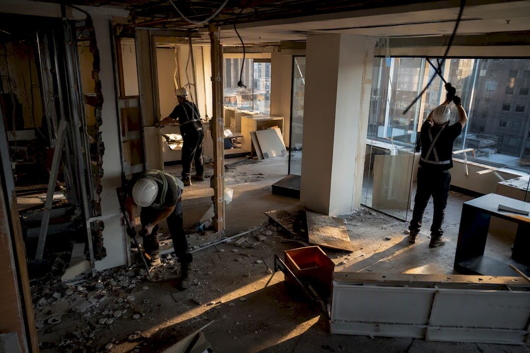 Workers stripping out interior office fitout