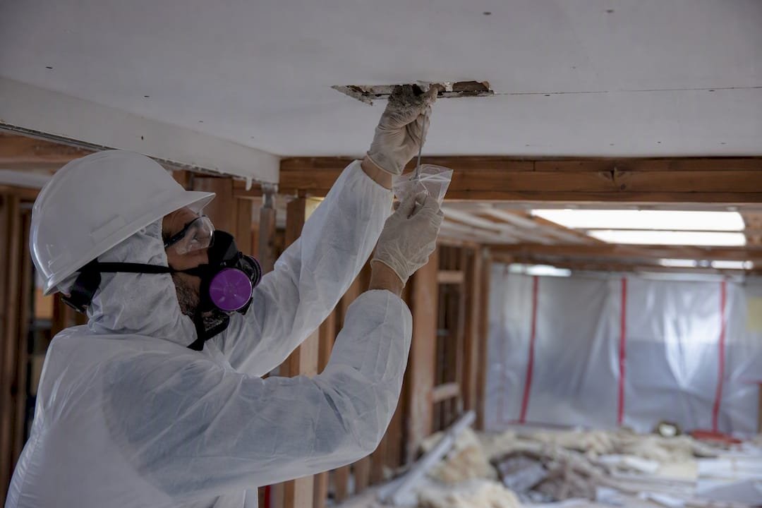 Inspector sampling asbestos material