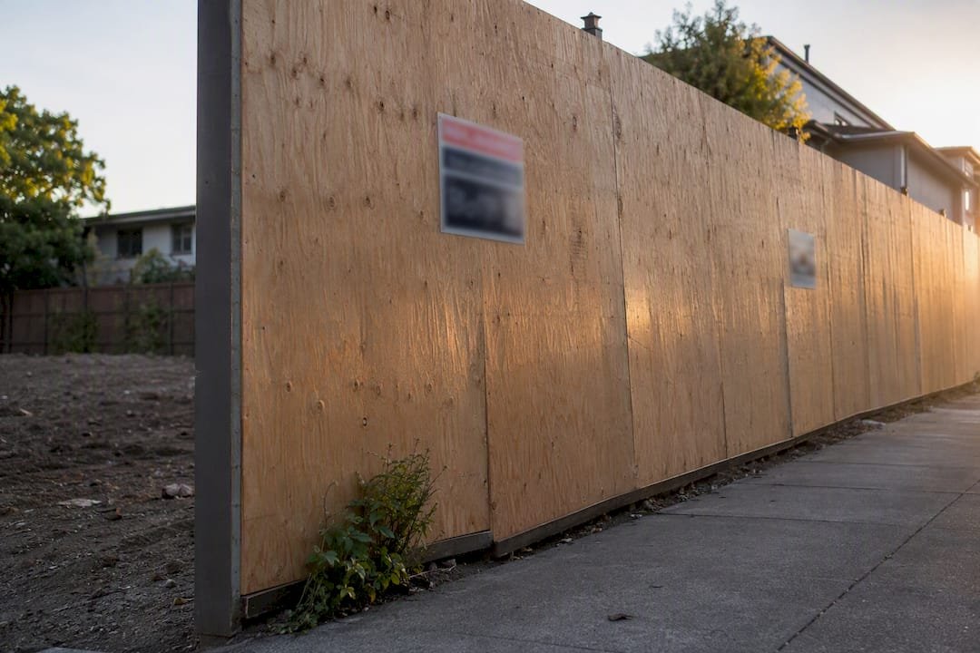 Temporary mesh fencing securing demolition site perimeter
