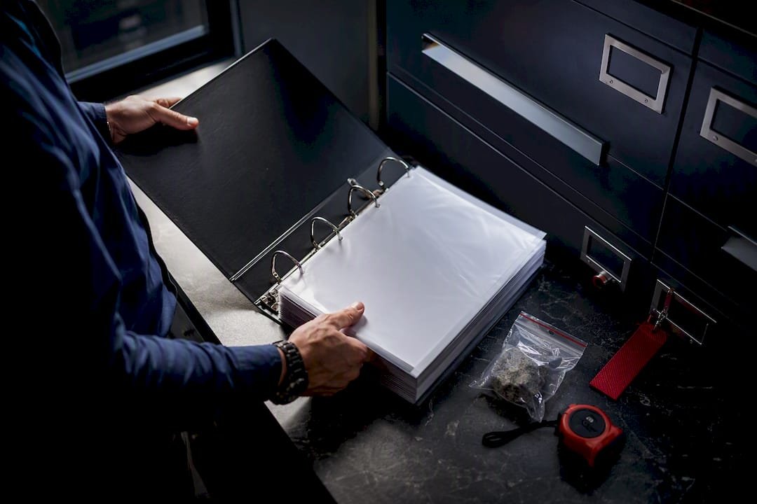 Property manager reviewing asbestos register binder