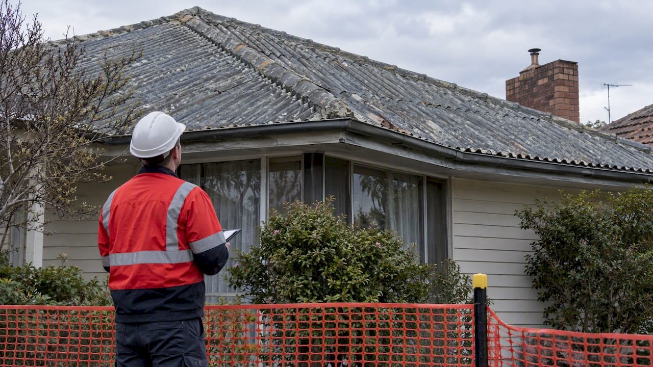 Weathered asbestos cement roof tiles on Australian home